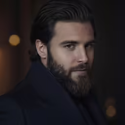 a close up of a man wearing a tuxedo