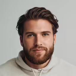 a man with a beard is looking at the camera