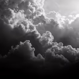 an airplane flying through the air surrounded by clouds