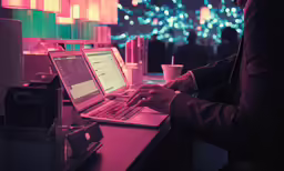 a person uses a laptop computer on a desk
