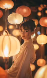 an asian woman standing under some lights