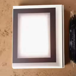 an opened photo book with camera inside