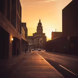 an empty road that has cars parked along the side