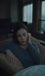 there is a woman that is sitting down on a couch