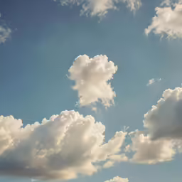some very fluffy white clouds in the sky