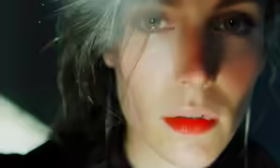 a beautiful woman with bright red lipstick on her lips