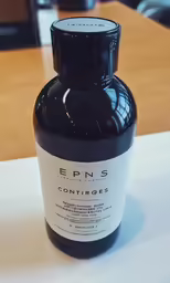 a bottle of liquid sitting on a counter