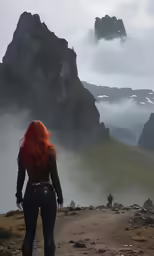 woman looking over mountain and forest with fog