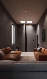 a modern living room with two leather couches