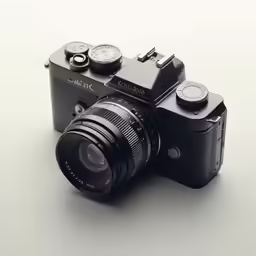a black camera with three small dials on it