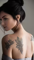 an artistic photograph of a woman with tattoos