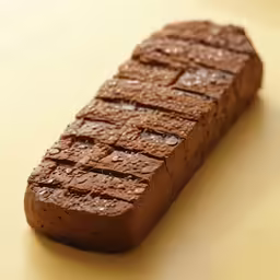 an image of chocolate candy on a yellow surface