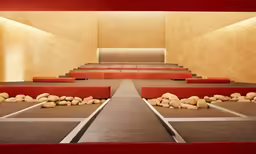 a room with red benches and white lines and rocks