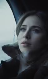 a woman in a car looking out the window