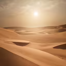 desert landscape with sun shining in the distance