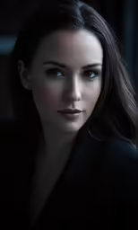 the woman in black jacket has dark eyes and is looking into the distance