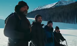 three men standing in the snow outside