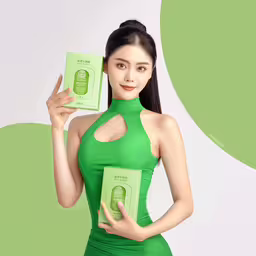 a woman is holding up some fake soap,a girl in a green dress holding up a book