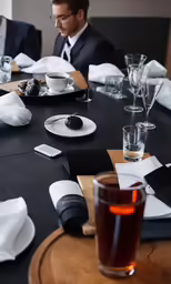 man sitting at table with dessert and glass of juice