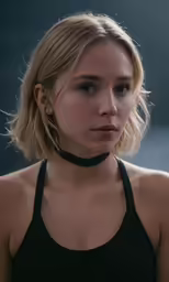 a young blonde woman wearing a black halter top