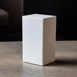 a small square cube box sits on a table