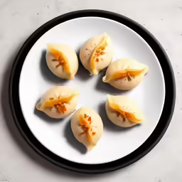 there are several dumplings in a plate on the table