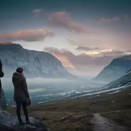 there is two people that are standing on top of a mountain
