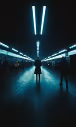two people standing in a long tunnel in the dark