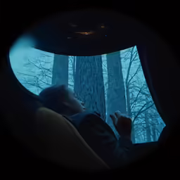 a woman that is sleeping on a couch in the dark