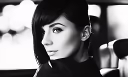 a woman that is sitting down wearing black clothes