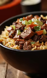 a big bowl of food on a wooden table