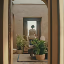 there is a woman that is looking at herself in the mirror