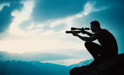 a man with a rifle sitting on a rock