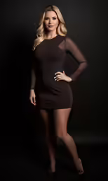 beautiful blonde posing in a dress while wearing sexy lingerie