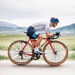 the man is riding his bike around the bend