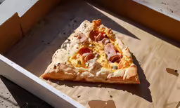 the pizza has ham and cheese on it