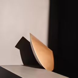 a sculpture with a curved face sitting on top of a shelf