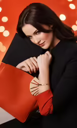 the woman is holding a purse in her hand