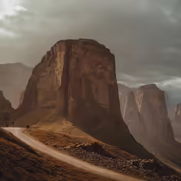 a large tall mountain with a long road going down it