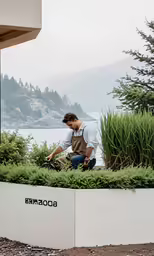 a man that is standing up near some plants