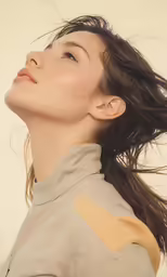 a woman with her long hair flying through the air