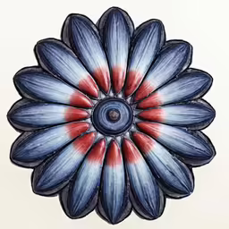 a blue, white and red flower sitting on top of a table