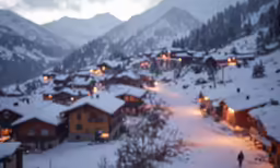 an image of snow covered town on a mountain at night