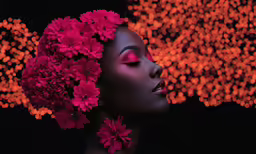an african american woman with dark make up and flowers in her hair