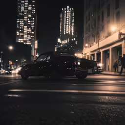 old american car driving down the street in front of a building
