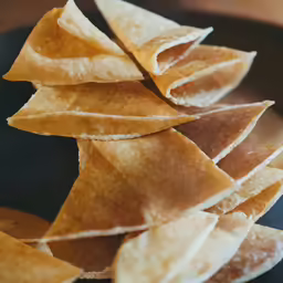 some very pretty tortilla chips that have been cut in to small triangles