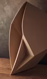 an origami sculpture is shown in brown paper