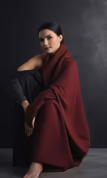 a woman poses in black and red clothing