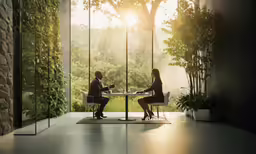 a couple sitting at a table talking to each other
