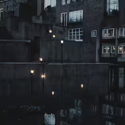 a building sits in front of a body of water